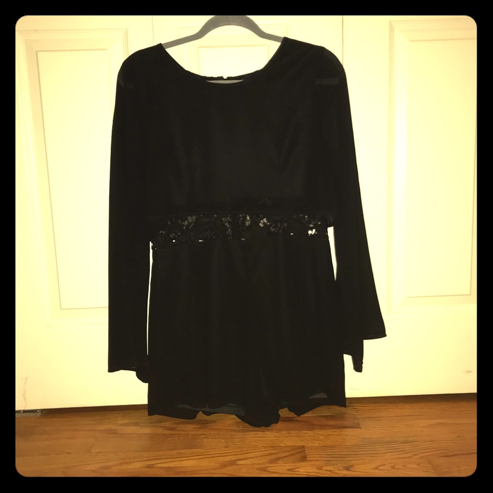 Never worn. Black romper with lace underlay.